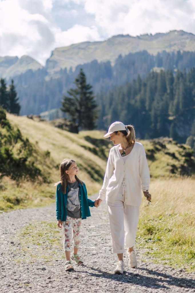 Mother and daughter in the Alps in summer